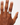 Hand wearing a silver ring on a white background
