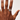 Hand wearing a ring on a plain background
