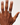 Hand wearing a ring on a plain background