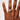 Hand wearing a ring on a plain background