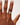 Hand wearing a ring on a plain background