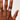 Hand wearing a ring on a plain background