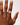 Hand wearing a ring on a plain background