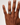 Hand wearing a ring on a plain background