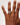Hand wearing a diamond ring on a plain background