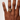 Hand wearing a ring on a plain background