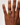 Hand wearing a ring on a plain background