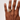 Hand wearing a gold ring on a plain background