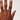 Hand with a ring on a plain background