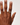 Hand with a ring on a plain background
