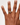 Hand with a ring on a plain background