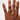 Hand wearing a gold ring on a plain background