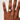 Hand wearing a ring on a plain background