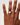 Hand wearing a ring on a plain background
