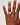 Hand wearing a diamond ring on a plain background