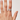 Hand wearing a ring on a plain background