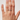 Hand wearing a ring on a plain background