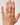 Hand wearing a ring on a plain background